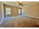 Spacious main bedroom featuring soft carpeting, ceiling fan, and large windows for ample natural light at 2141 Bradbury Rd # 1, Moreland, GA 30259