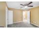 Bedroom features neutral walls and carpet, a ceiling fan, and natural light at 1009 Lear Dr, Locust Grove, GA 30248