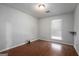 A well-lit bedroom with hardwood floors, window and light fixture at 4097 Cripple Creek Nw Dr, Kennesaw, GA 30144