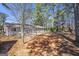 Home featuring a wood deck and spacious backyard surrounded by trees at 4097 Cripple Creek Nw Dr, Kennesaw, GA 30144