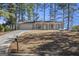 Front exterior view of the charming single-story home with a driveway and front lawn at 4097 Cripple Creek Nw Dr, Kennesaw, GA 30144
