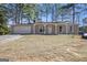 Charming ranch-style home featuring a covered porch, attached garage, and mature trees at 4097 Cripple Creek Nw Dr, Kennesaw, GA 30144
