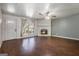 Open living room with hardwood floors, a stone fireplace, and a ceiling fan at 4097 Cripple Creek Nw Dr, Kennesaw, GA 30144