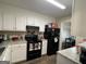 Efficient kitchen with modern appliances and white cabinets at 5509 Park Place South, Atlanta, GA 30349