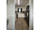 View of kitchen featuring white cabinets and modern black appliances at 5509 Park Place South, Atlanta, GA 30349