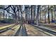 Large backyard featuring mature trees and a storage shed in a wooded area at 30 Fairfield Dr, Ellenwood, GA 30294