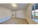 Bright bedroom featuring neutral carpet, closet, overhead lighting, and natural light from a window at 30 Fairfield Dr, Ellenwood, GA 30294