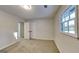 Bedroom featuring neutral carpet, closet, overhead lighting, and natural light from a window at 30 Fairfield Dr, Ellenwood, GA 30294