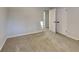 Bedroom featuring neutral carpet, white walls, base molding, and access to other rooms at 30 Fairfield Dr, Ellenwood, GA 30294
