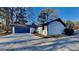 Side view of a one-story home featuring a dark blue garage door and concrete driveway at 30 Fairfield Dr, Ellenwood, GA 30294