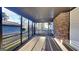 The screened porch offers a view of the backyard, with a red brick wall at 30 Fairfield Dr, Ellenwood, GA 30294