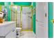 Bright bathroom featuring white cabinets, tile floor, and a gold-trimmed shower with white tile at 1214 Greenridge Ln, Lithonia, GA 30058