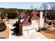 Lovely traditional-style home with a three-car garage and well-manicured landscaping on a sunny day at 1214 Greenridge Ln, Lithonia, GA 30058