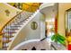 Grand foyer features a curved staircase with wood and iron accents and marble floors at 1214 Greenridge Ln, Lithonia, GA 30058