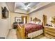 Spacious main bedroom with a tray ceiling, 4-poster bed, and ample natural light at 1214 Greenridge Ln, Lithonia, GA 30058