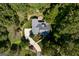 Aerial view of a home surrounded by dense trees, complemented by an expansive driveway at 2275 Honeysuckle Se Ln, Smyrna, GA 30080