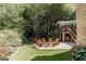 A serene backyard featuring a stone patio with outdoor seating area at 2275 Honeysuckle Se Ln, Smyrna, GA 30080