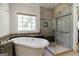 Luxurious bathroom featuring a soaking tub, tiled shower, and stylish fixtures at 2275 Honeysuckle Se Ln, Smyrna, GA 30080