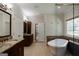 This large bathroom features dual vanities, a soaking tub, and closet space at 2275 Honeysuckle Se Ln, Smyrna, GA 30080