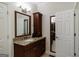 Elegant bathroom features a granite countertop vanity and adjoining room at 2275 Honeysuckle Se Ln, Smyrna, GA 30080