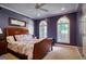 Inviting bedroom with a wooden bed frame, neutral carpeting, and natural light from the arched windows at 2275 Honeysuckle Se Ln, Smyrna, GA 30080