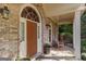 Close-up of the arched front door and cozy porch, highlighting architectural details and warm ambiance at 2275 Honeysuckle Se Ln, Smyrna, GA 30080
