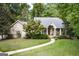 Charming brick home with a manicured lawn and lush landscaping creates a welcoming curb appeal at 2275 Honeysuckle Se Ln, Smyrna, GA 30080