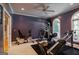 Spacious home gym featuring multiple exercise machines, a ceiling fan, and natural light from large windows at 2275 Honeysuckle Se Ln, Smyrna, GA 30080