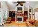 Living room featuring vaulted ceiling, fan, fireplace with mantel, hardwood floors and comfortable seating at 2275 Honeysuckle Se Ln, Smyrna, GA 30080
