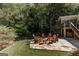 Stone patio area with an arrangement of chairs in a wooded backyard setting at 2275 Honeysuckle Se Ln, Smyrna, GA 30080