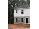 Two-story home features gray and white siding, dark roof, and surrounded by lush trees at 7266 Crestside Dr # 65, Austell, GA 30168