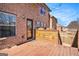 Second story wood back deck featuring an exterior brick wall and a back door at 124 Shelton Dr, Mcdonough, GA 30252