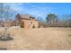 Exterior shot of home, showcasing a large lawn and wooded area beyond the manicured backyard at 124 Shelton Dr, Mcdonough, GA 30252