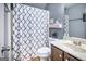 Clean bathroom with a patterned shower curtain, a well-lit vanity, and modern fixtures at 124 Shelton Dr, Mcdonough, GA 30252