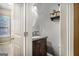 Bathroom with a wood vanity, undermount sink, and a view out the window at 124 Shelton Dr, Mcdonough, GA 30252