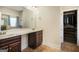 Bright bathroom with double sinks, a large mirror, and access to closet at 124 Shelton Dr, Mcdonough, GA 30252