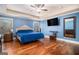 Well-lit bedroom with hardwood floors, natural light and TV at 124 Shelton Dr, Mcdonough, GA 30252