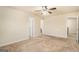 Neutral-toned bedroom featuring a ceiling fan, neutral carpeting, and multiple doorways for flexible access at 124 Shelton Dr, Mcdonough, GA 30252