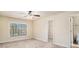 Bright bedroom featuring a large window, a ceiling fan, and neutral carpeting, creating a comfortable ambiance at 124 Shelton Dr, Mcdonough, GA 30252