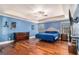 Spacious bedroom with hardwood floors, a ceiling fan, and natural light at 124 Shelton Dr, Mcdonough, GA 30252