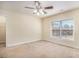 Bright and airy bedroom with a ceiling fan, a large window, and neutral carpet, creating a serene atmosphere at 124 Shelton Dr, Mcdonough, GA 30252