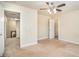 Neutral bedroom with an open doorway, ceiling fan, and a view into another room, offering versatility at 124 Shelton Dr, Mcdonough, GA 30252