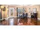 Well lit dining room with hardwood floors, decorative clock and access to the outside deck at 124 Shelton Dr, Mcdonough, GA 30252
