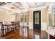 Elegant dining room featuring a coffered ceiling, hardwood floors, and an abundance of natural light at 124 Shelton Dr, Mcdonough, GA 30252