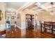 Open dining room adjacent to the living area with wainscoting, hardwood floors and modern chandelier at 124 Shelton Dr, Mcdonough, GA 30252