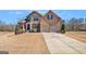 Beautiful two-story brick and stone home with a well-manicured lawn and a two-car garage at 124 Shelton Dr, Mcdonough, GA 30252