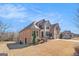 Lovely home with brick exterior, manicured landscaping, and a spacious lawn with a long driveway at 124 Shelton Dr, Mcdonough, GA 30252