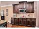 Kitchen featuring dark wood cabinetry, granite countertops, and stainless appliances at 124 Shelton Dr, Mcdonough, GA 30252