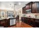 Kitchen featuring dark wood cabinets, granite countertops, and stainless appliances at 124 Shelton Dr, Mcdonough, GA 30252