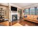 Cozy living room featuring a fireplace, a large TV, and comfortable seating with natural lighting at 124 Shelton Dr, Mcdonough, GA 30252